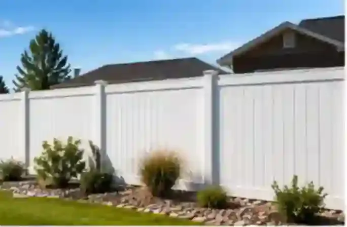 Finished white vinyl privacy fence installed on a Burley property